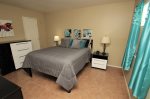 Bedroom offers a queen bed and walk in closet